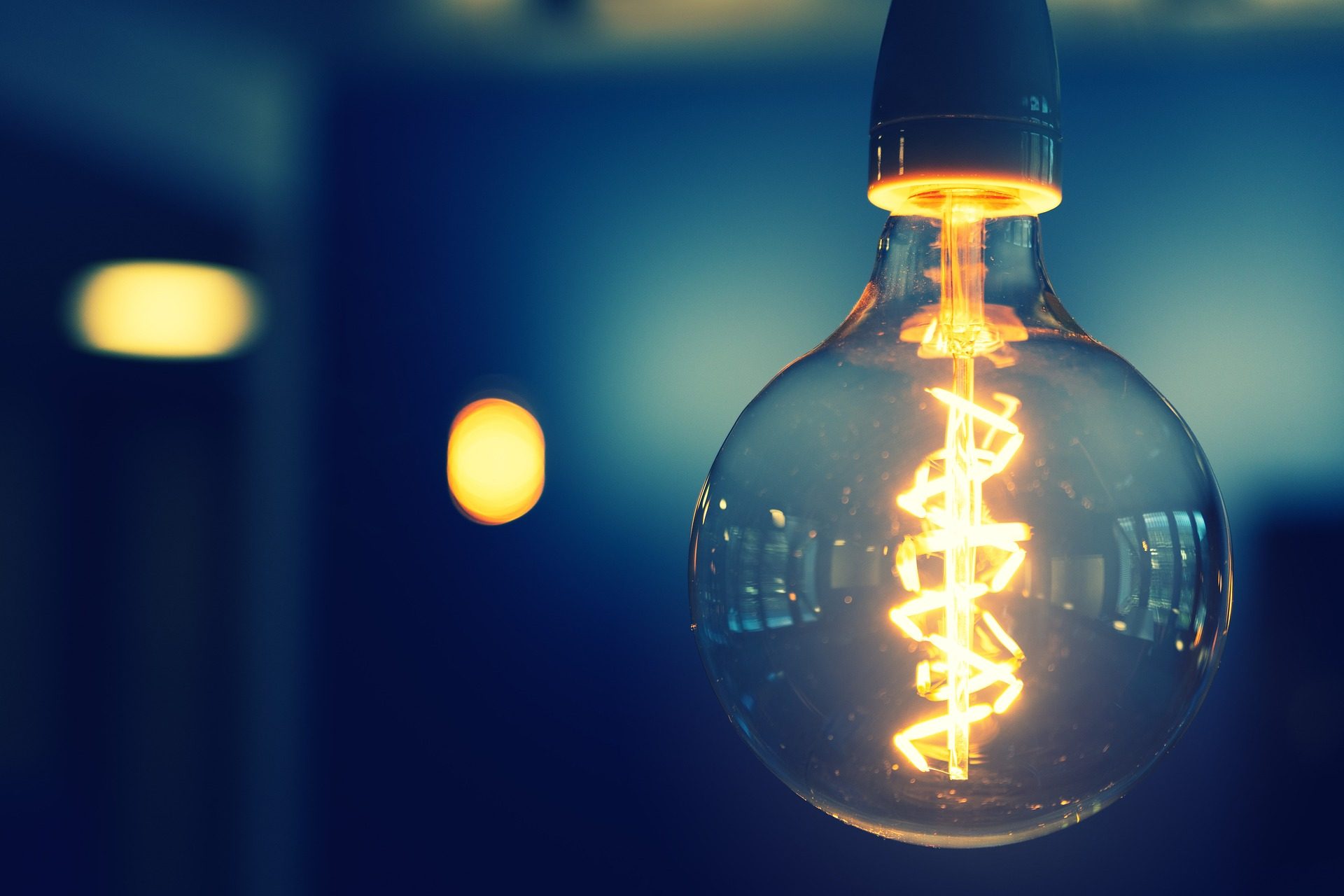 vintage looking lightbulb providing subtle lighting with blue background room